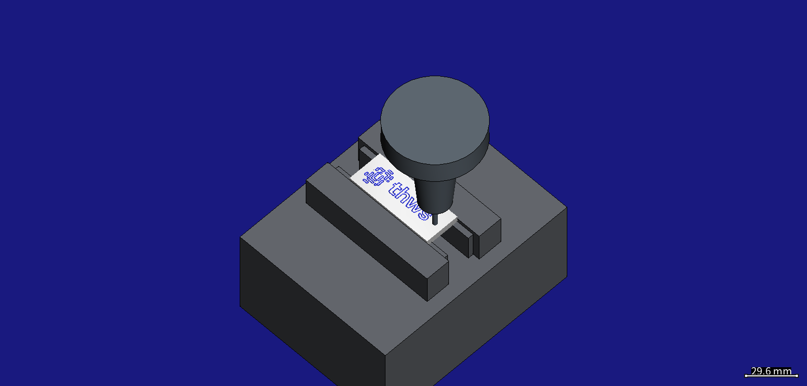 The drill in its shrink-fit chuck at the end of the plate, with the logo and the letters already engraved