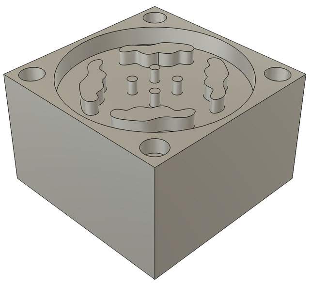 The data set's rendering of part 9: a round pocket holding four wavy islands and four small pins, with holes in the block's corners